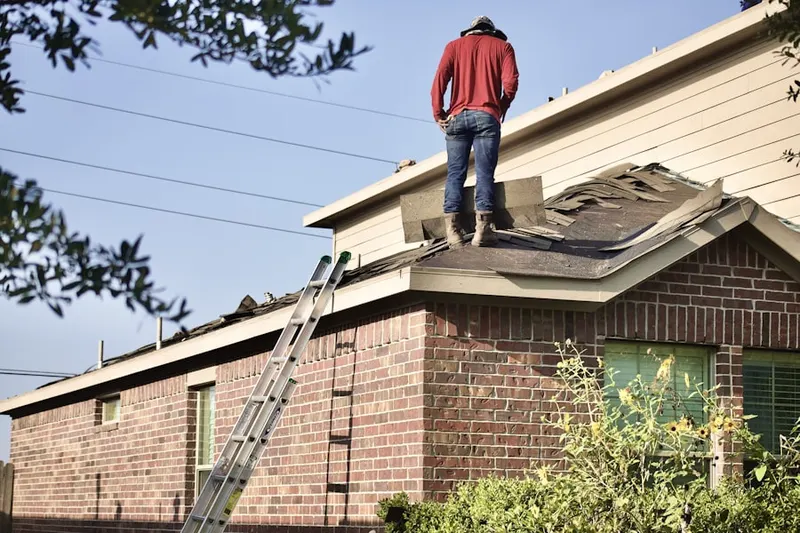 Professional roofer working on a residential roof in Bowie